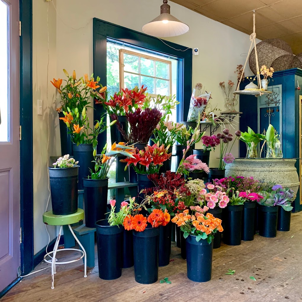 store setup of pink and orange florals in buckets
