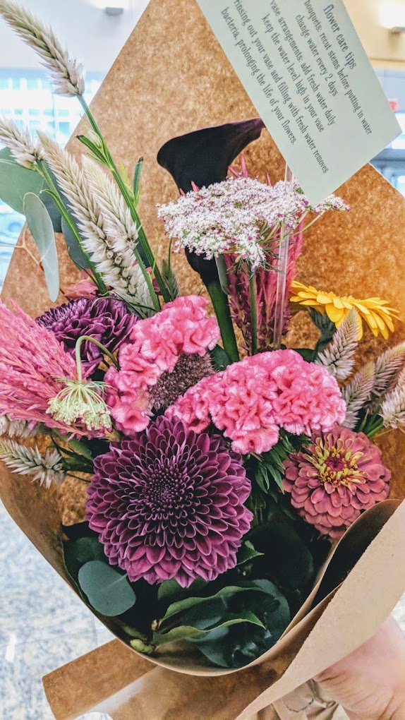 pink-themed bouquet in simple brown paper